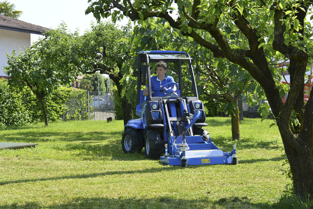 MultiOne mini loader 2 series with lawn mower in a garden