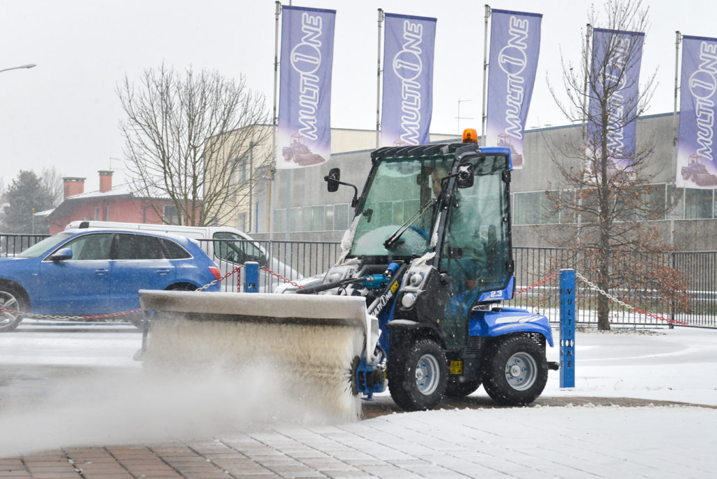 MultiOne mini loader 2 series with rotary broom cleaning in front of multione venue