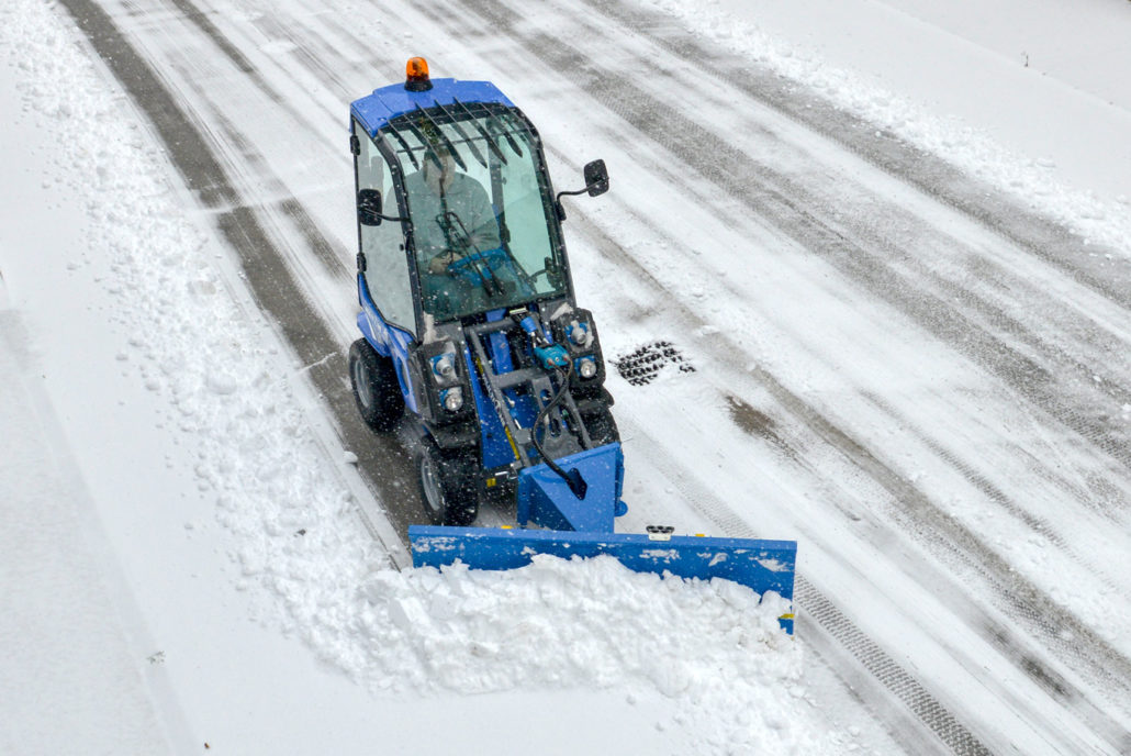 multione mini loader series 2 with snow blade, cleaning a street, upper view