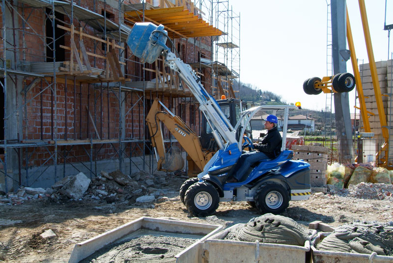 man using a multione cement mixer while working in a construction site