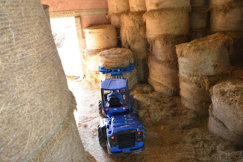 bale grabber moving a hay bale from upper view