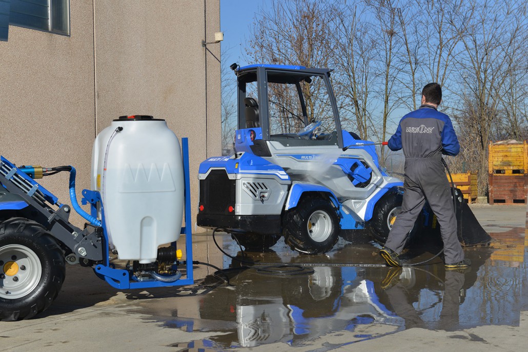 high pressure washer used to clean a mini loader